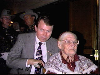 Bob Watson escorts Ms. Alberta Martin, said to be the last surviving widow of a Confederate soldier